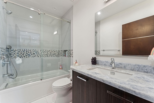 full bathroom featuring enclosed tub / shower combo, toilet, tile floors, and vanity