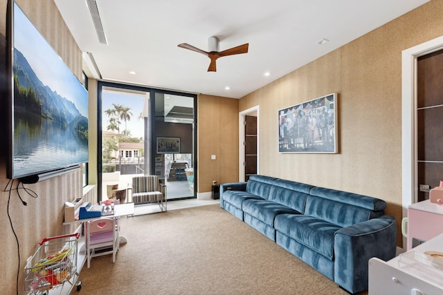 carpeted living room featuring ceiling fan