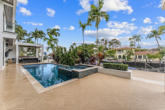 view of pool featuring an in ground hot tub and a patio