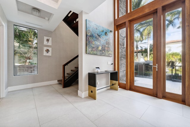 doorway featuring plenty of natural light and light tile flooring