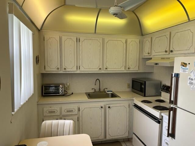 kitchen featuring custom range hood, white appliances, sink, and a wealth of natural light