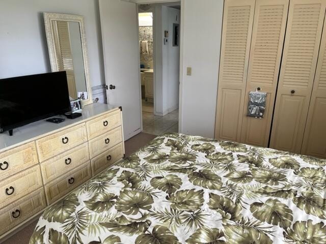 tiled bedroom featuring a closet