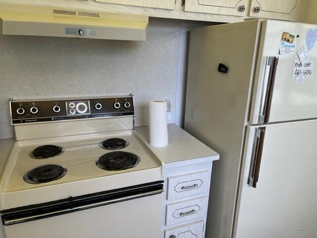 kitchen featuring fume extractor and white appliances