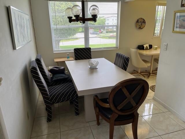 tiled dining area featuring a notable chandelier