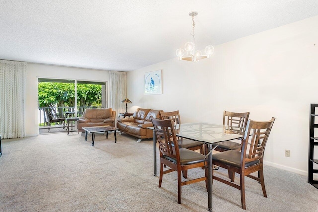 carpeted dining room with a textured ceiling and a chandelier