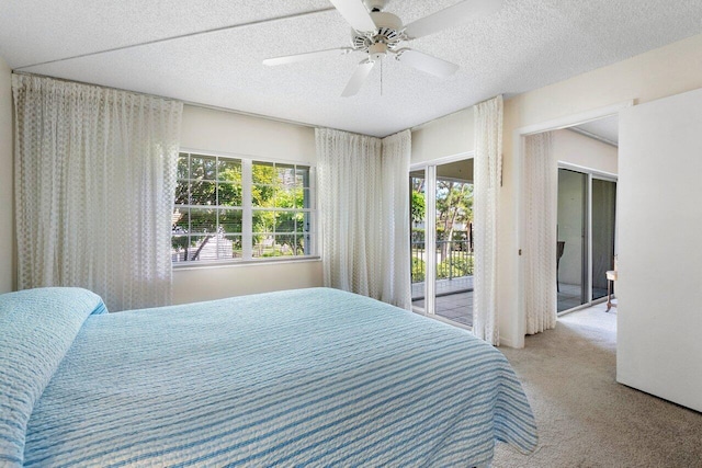 bedroom with ceiling fan, multiple windows, and a textured ceiling