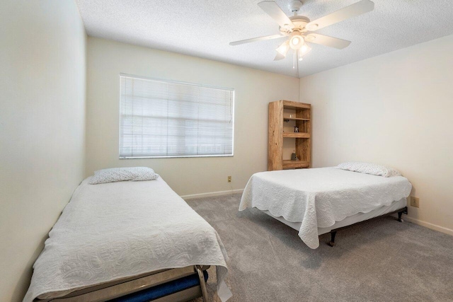 bedroom featuring carpet flooring, a textured ceiling, and ceiling fan