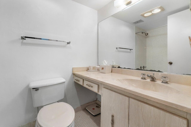 bathroom with tile floors, oversized vanity, and toilet