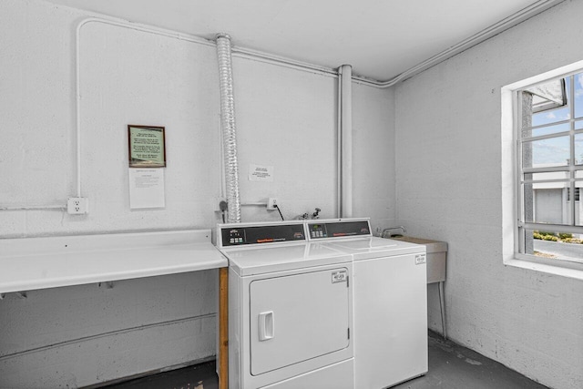 laundry room featuring washer and clothes dryer, washer hookup, sink, and a wealth of natural light