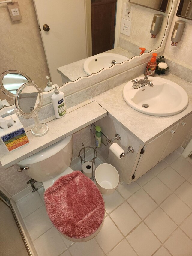 bathroom featuring tile patterned floors, vanity, and toilet