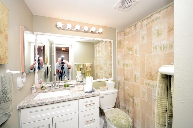 bathroom featuring toilet and vanity