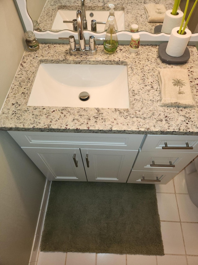 bathroom with tile patterned flooring and vanity