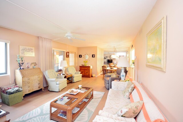 living room featuring ceiling fan and light hardwood / wood-style flooring