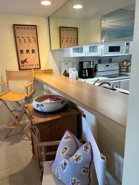 kitchen with decorative backsplash and white appliances