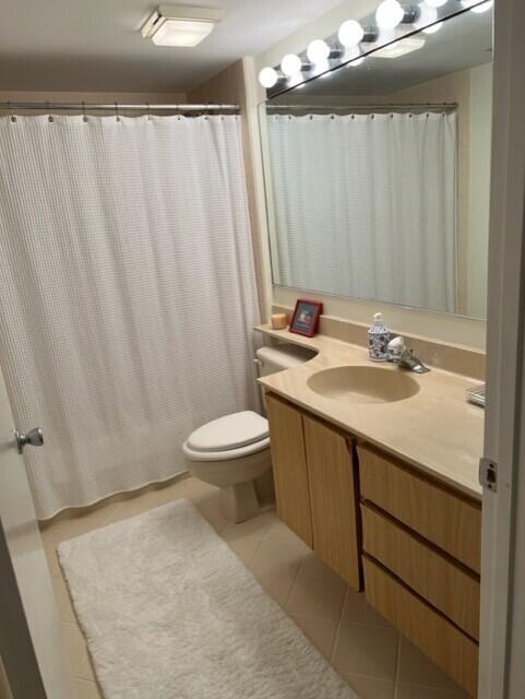 bathroom with tile patterned flooring, vanity, and toilet