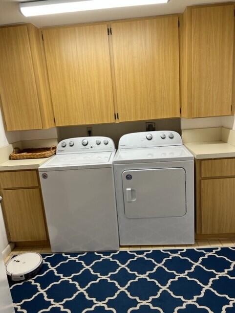 laundry room with cabinets and washer and dryer