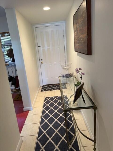 entryway with light tile patterned floors