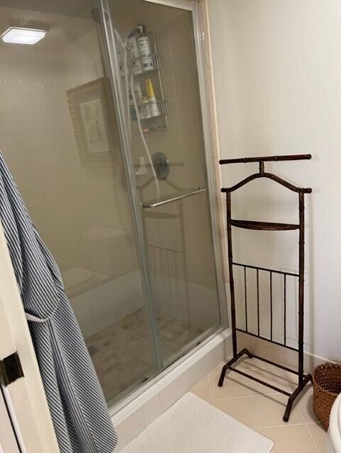 bathroom featuring tile patterned floors and an enclosed shower