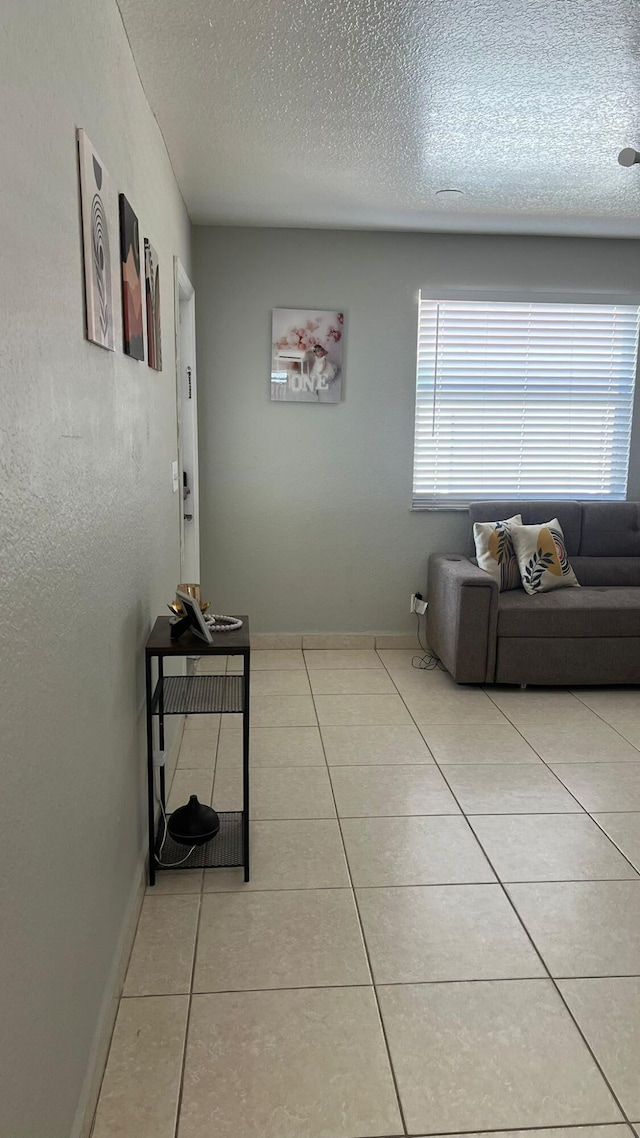 living room with light tile floors and a textured ceiling