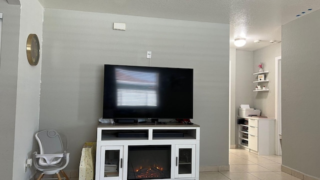 living room with light tile floors and a textured ceiling