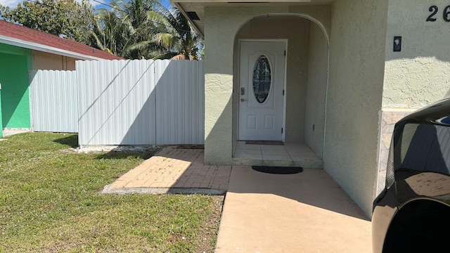 doorway to property featuring a yard