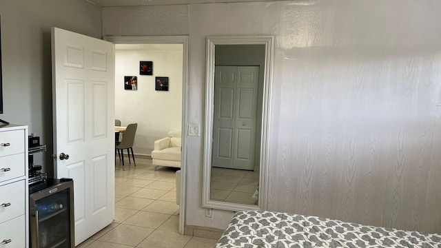 bedroom featuring light tile flooring and wine cooler