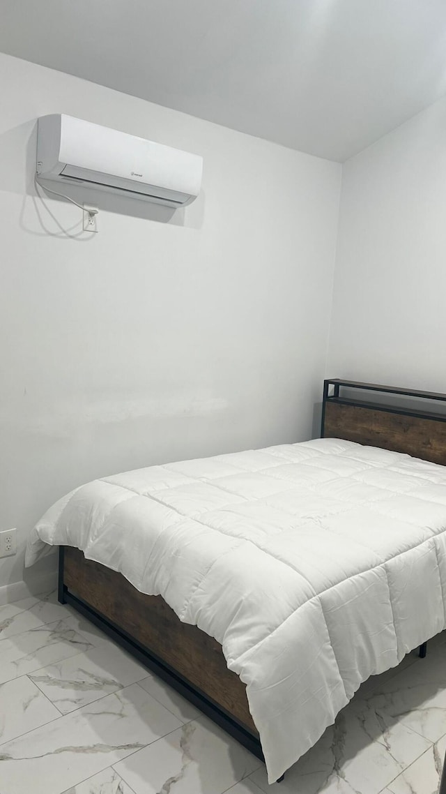 bedroom featuring a wall mounted AC and light tile flooring