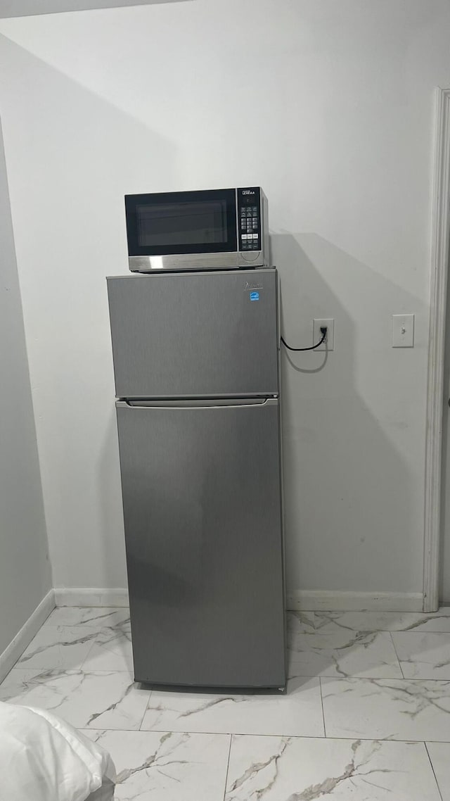 details with light tile floors and appliances with stainless steel finishes