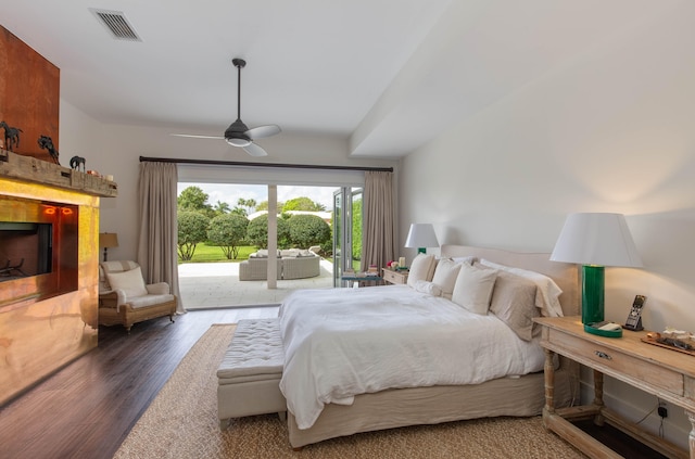 bedroom with access to exterior, ceiling fan, and dark wood-type flooring