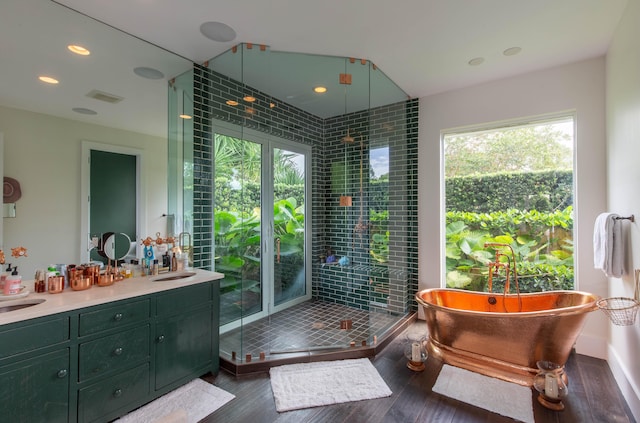 bathroom featuring independent shower and bath and vanity