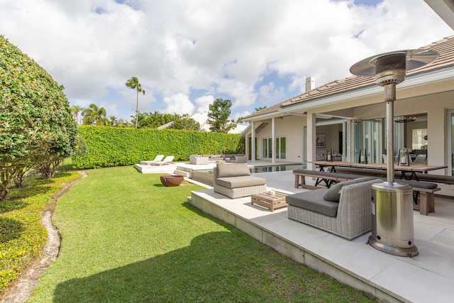 view of yard with a patio and an outdoor living space with a fire pit