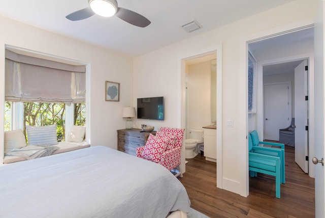 bedroom featuring connected bathroom, ceiling fan, and dark wood-type flooring