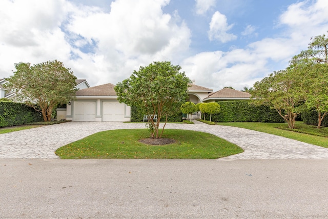 view of front of house with a front lawn and a garage