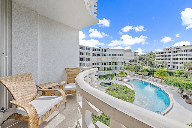 balcony featuring a community pool