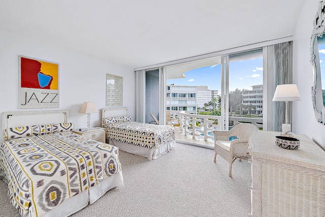 carpeted bedroom featuring floor to ceiling windows