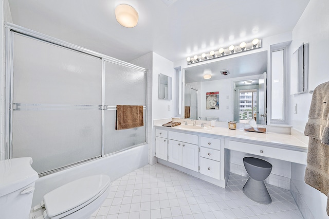 full bathroom with toilet, bath / shower combo with glass door, vanity, and tile flooring