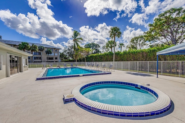 community pool featuring a patio area and fence