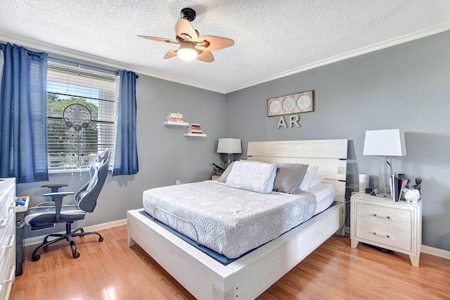 bedroom with a textured ceiling, light wood-type flooring, baseboards, and crown molding