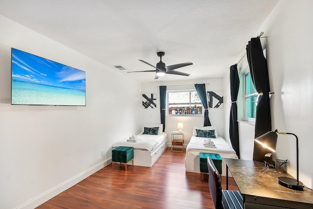 interior space featuring dark wood-type flooring, a textured ceiling, and ceiling fan