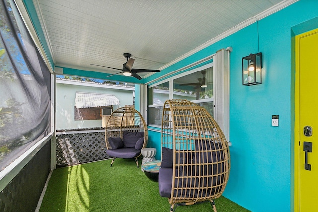 sunroom / solarium featuring ceiling fan