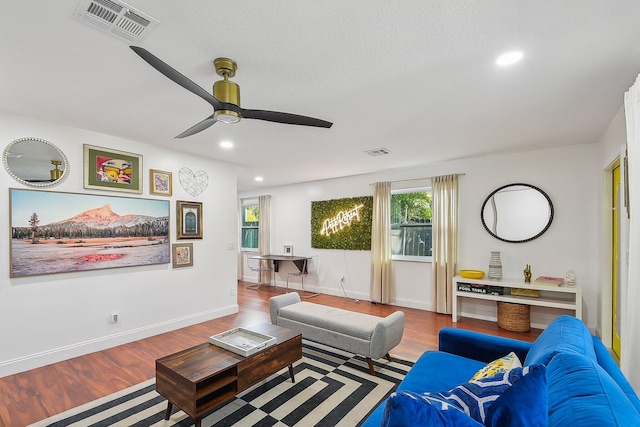 living room with ceiling fan and hardwood / wood-style floors