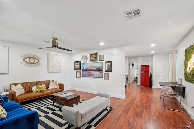 living room with ceiling fan and dark hardwood / wood-style flooring