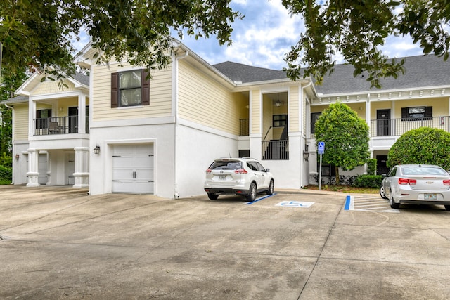 view of front facade featuring a balcony and a garage