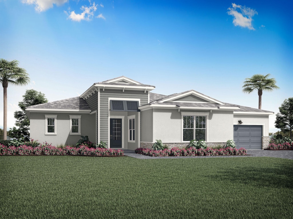 view of front of home with a front lawn and a garage