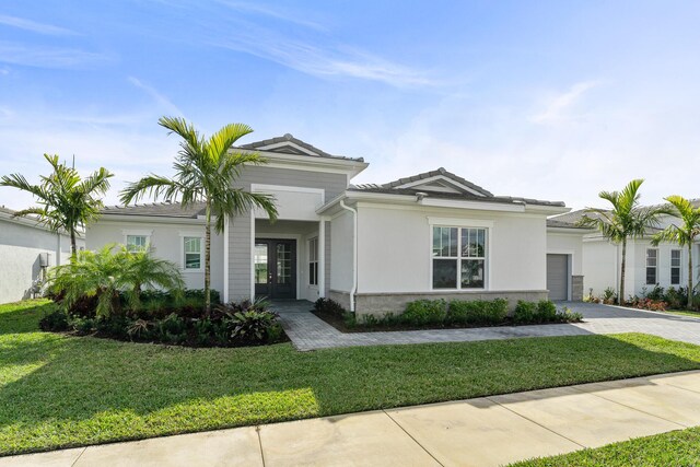 view of front of home with a front lawn and a garage