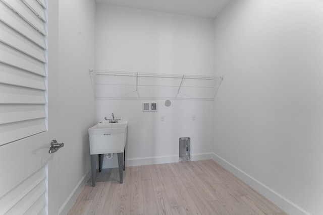 laundry room with hookup for a washing machine and light wood-type flooring