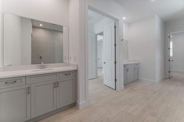 bathroom with vanity, hardwood / wood-style floors, and walk in shower