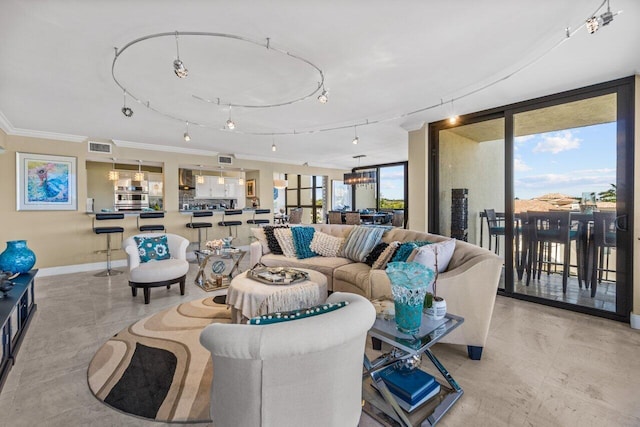 living room featuring expansive windows, crown molding, rail lighting, a notable chandelier, and light tile floors