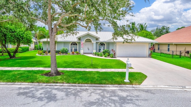 single story home featuring a garage and a front yard