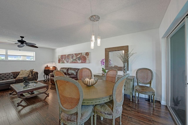 dining area featuring a textured ceiling, ceiling fan, and dark hardwood / wood-style flooring